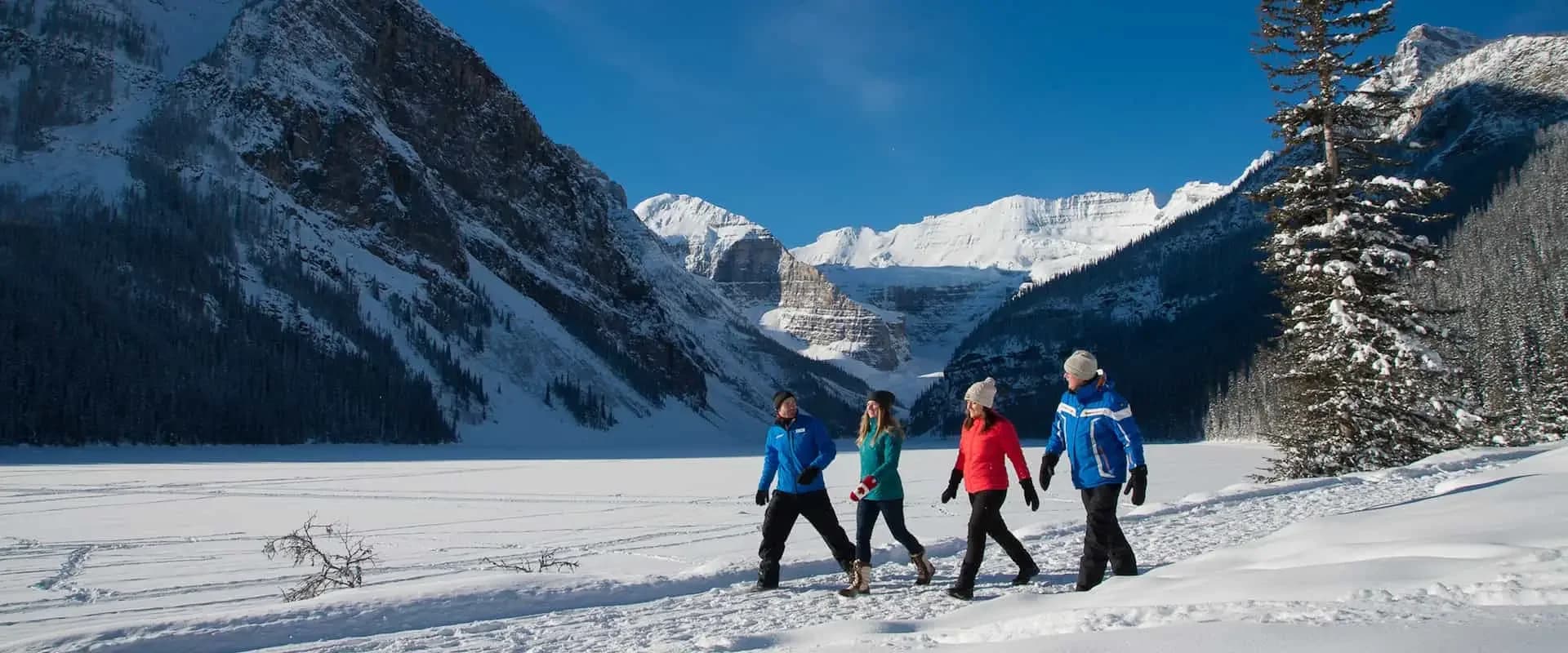 Stroll along the frozen lake shoreline on a Banff winter tour